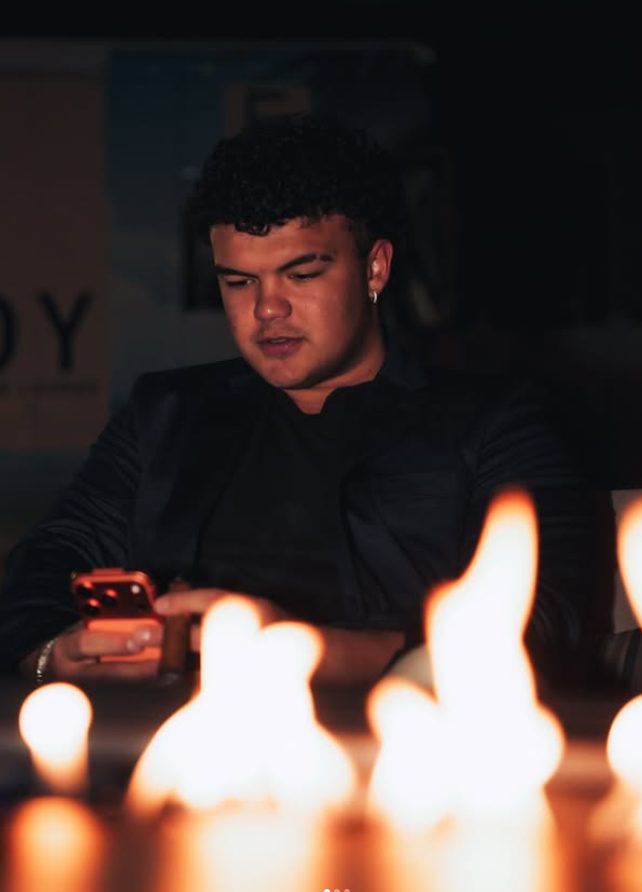 A member by the firelight at an evening gathering