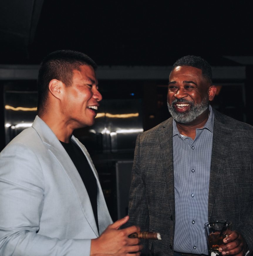Two members sharing a laugh over drinks