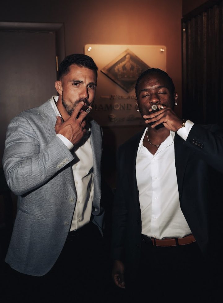 Two members enjoying cigars together