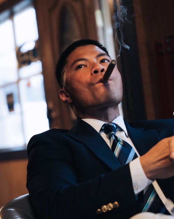 A member enjoying a cigar in a wood-panelled room
