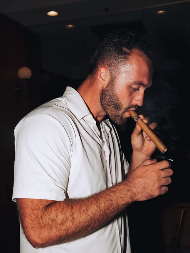A member lighting his cigar