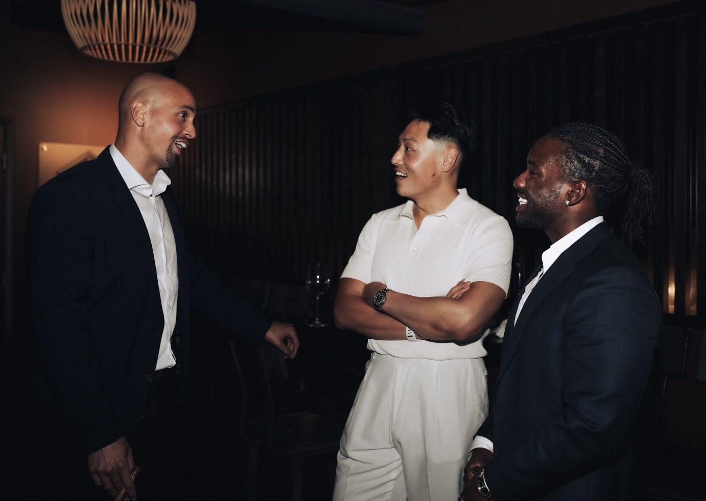 Three members in conversation at an event