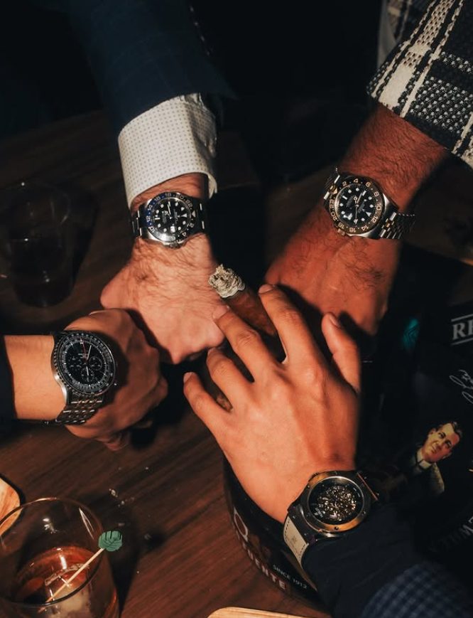 Members' watches gathered over the table